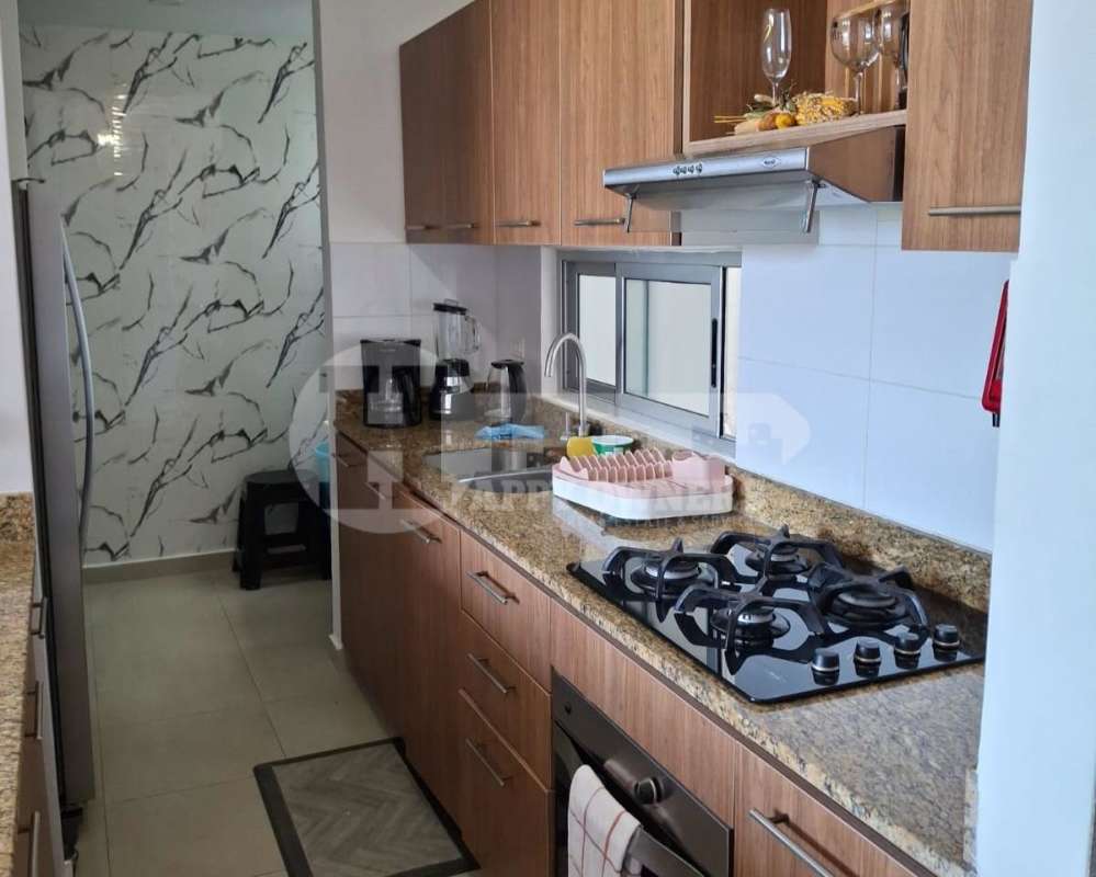 Kitchen with granite countertops and wood cabinets in PH Portoalegre Villa Lucre