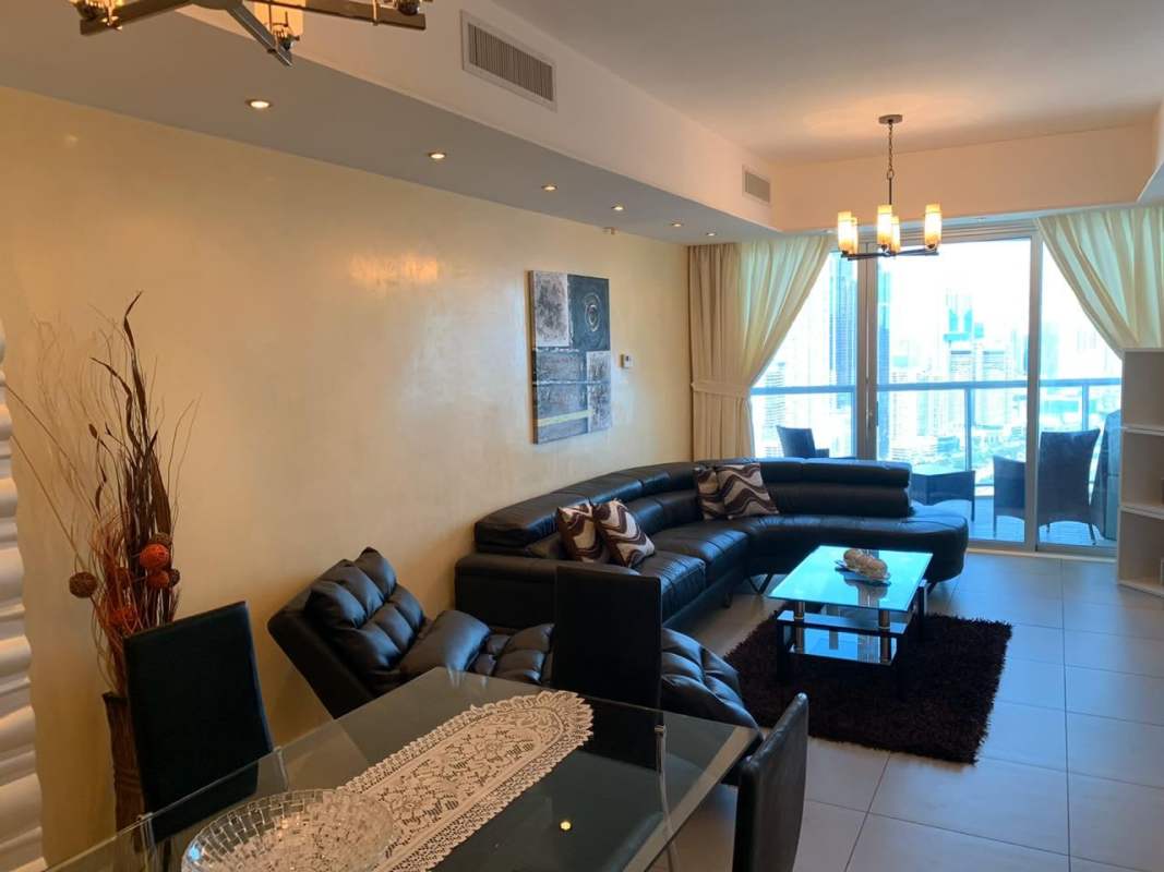 Modern living room with panoramic windows city and ocean views Yacht Club Panama