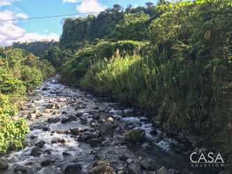 Rocky river flowing through tropical forest on 3 hectares land Boquerón