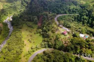 Bird's eye view of river, forest, and winding road on Boquerón Panama property