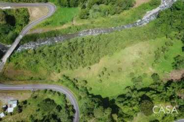 Aerial photograph of Boquerón river land with canyon forest and winding road