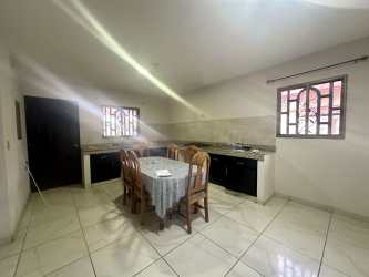 Kitchen with granite countertops, wood cabinets and dining space in house for sale in David Chiriquí