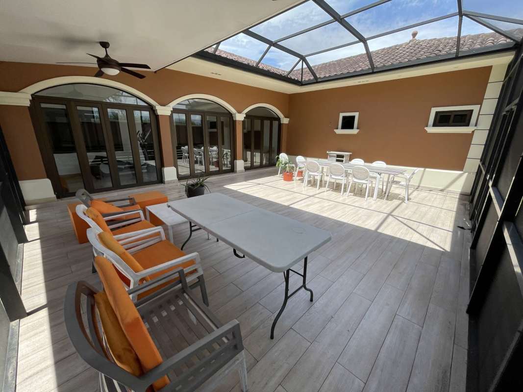 Remodeled enclosed patio terrace with glass roof and mosquito net at Sunset Coast house Panama