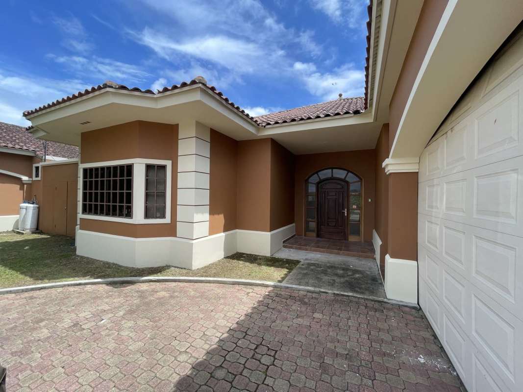 Spacious modern kitchen with granite island and wood cabinetry in house at Sunset Coast Costa Sur Panama
