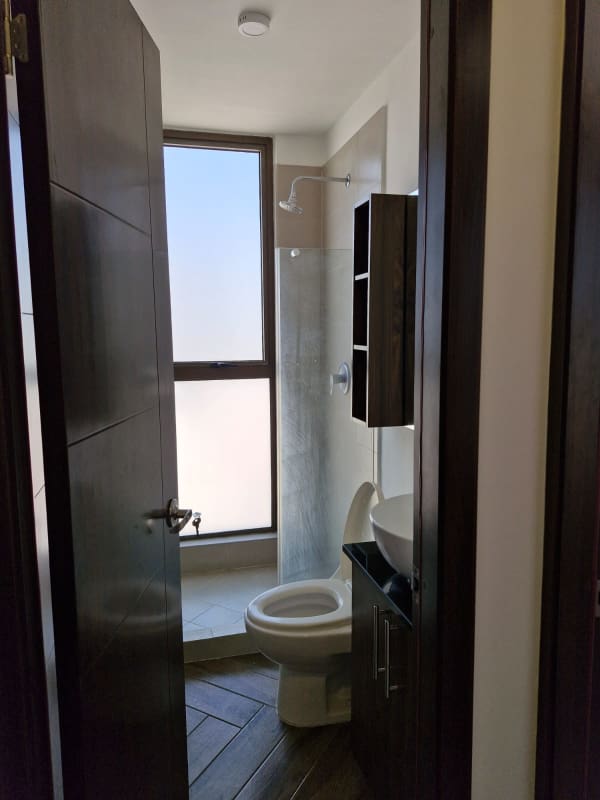 Modern kitchen with granite countertops, island sink, stylish cabinets at PH Mirador Vista Hermosa Panama City