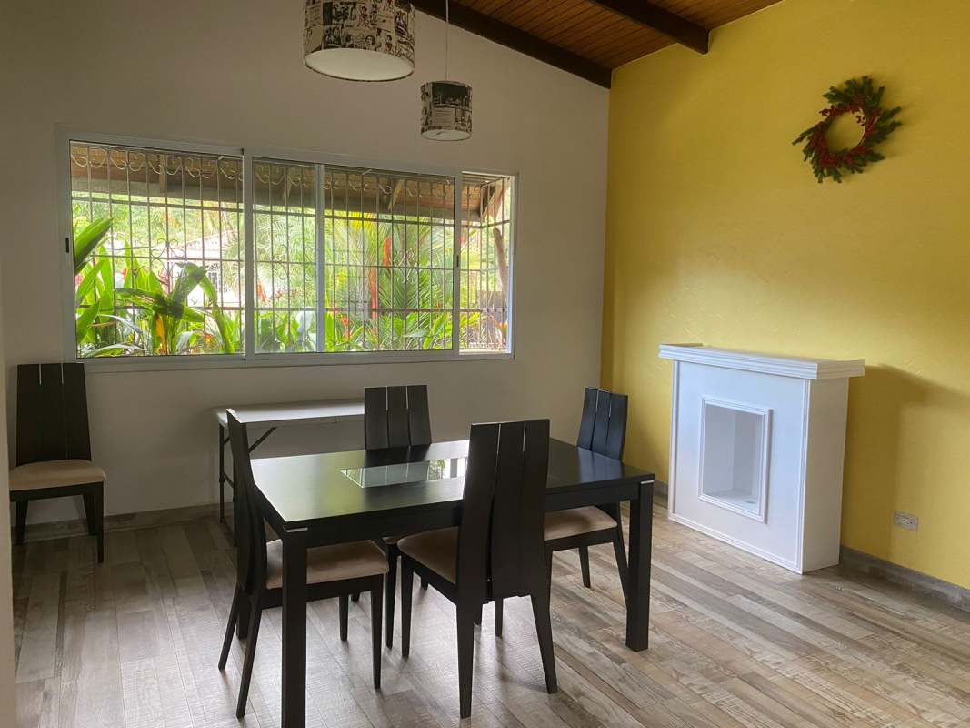Contemporary kitchen with island, stainless hood, and cabinetry Las Cumbres Panama