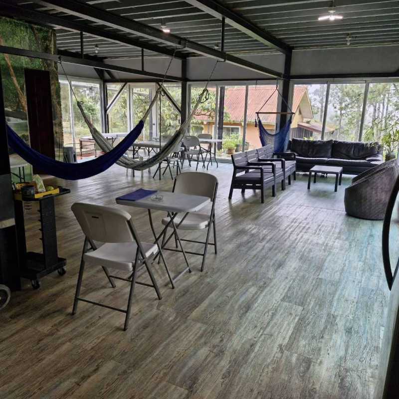 Open lounge area with hammocks large windows panoramic nature views Cerro Azul Panama