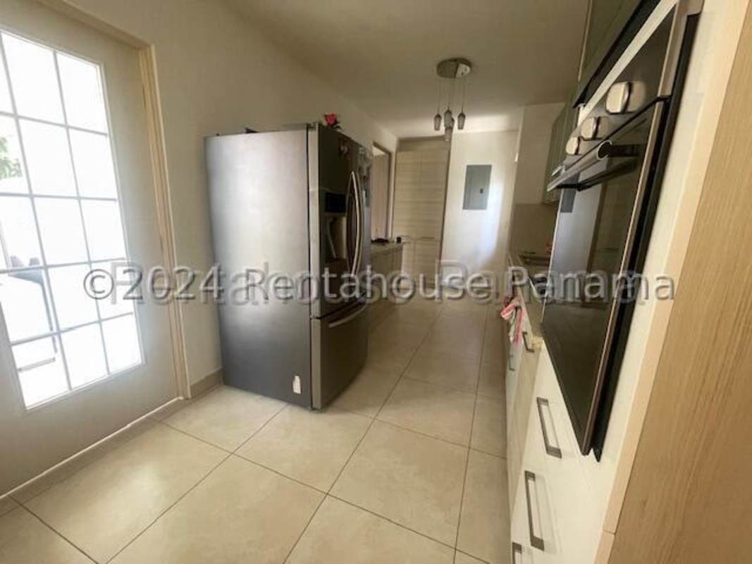 Open plan living and dining area with glass doors to backyard in Reserva de Versalles Panama