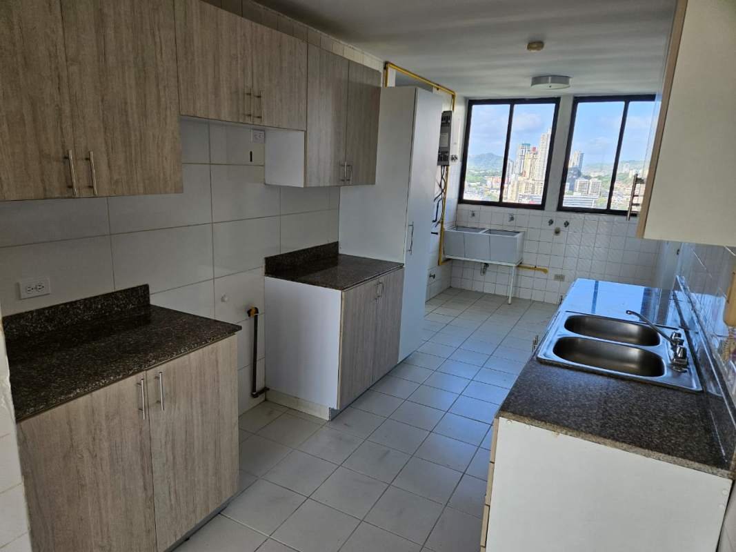 Kitchen with granite counters, upper and lower cabinets, city view windows in PH Pacific Hills Dos Mares