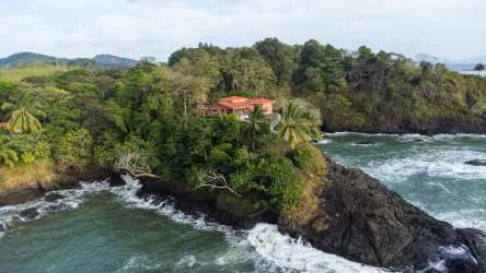 Primary bedroom featuring sliding doors with ocean views and hardwood cabinetry in Mariatos Veraguas