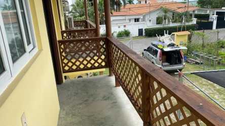 Second story balcony with wooden lattice railing Playa Gorgona multi-unit property Panama