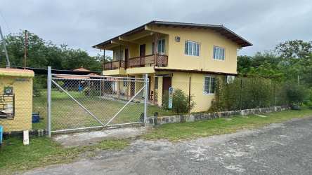 Rustic covered porch overlooking green backyard with trampoline Playa Gorgona Panama