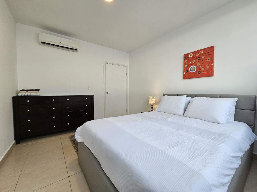 Open-plan living and dining room with panoramic windows and seaview balcony in PH Oasis Punta Pacifica Panama