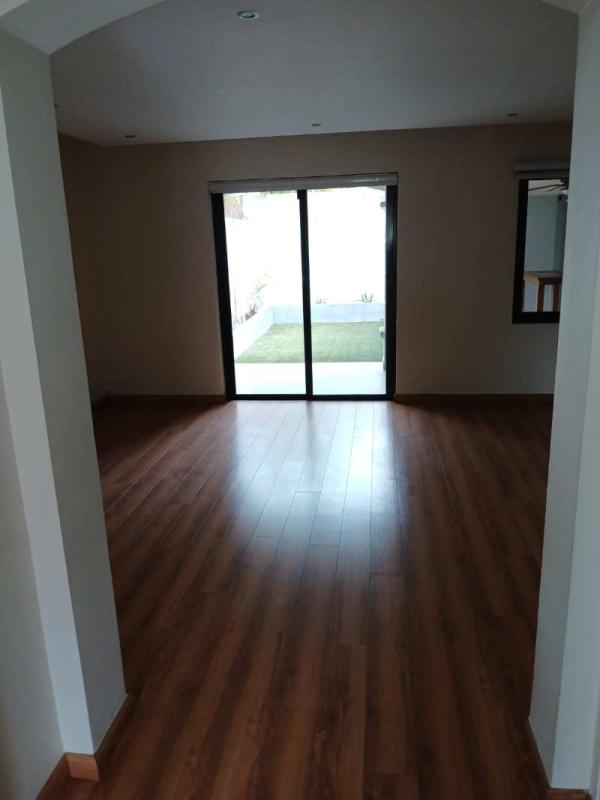 Two-story Mediterranean house with balcony, carport and tropical landscaping in Versalles Costa Sur Panama City