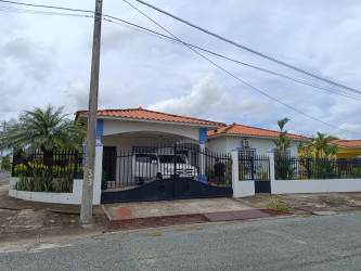 Backyard with swimming pool, slide, green lawn, and garden Penonomé Coclé Panama