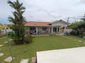 Traditional kitchen with wood cabinets, granite counters in Penonomé Panama