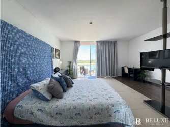 Modern bathroom with glass shower enclosure inside oceanview studio condo Playa Blanca Panama