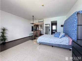 Modern kitchenette with granite countertops and cabinets in Playa Blanca studio condo Panama