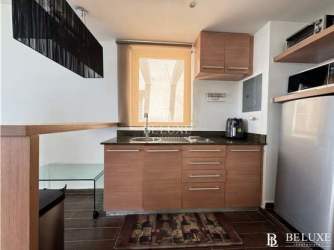 Bright studio apartment interior with ocean-facing balcony access at Town Center Playa Blanca