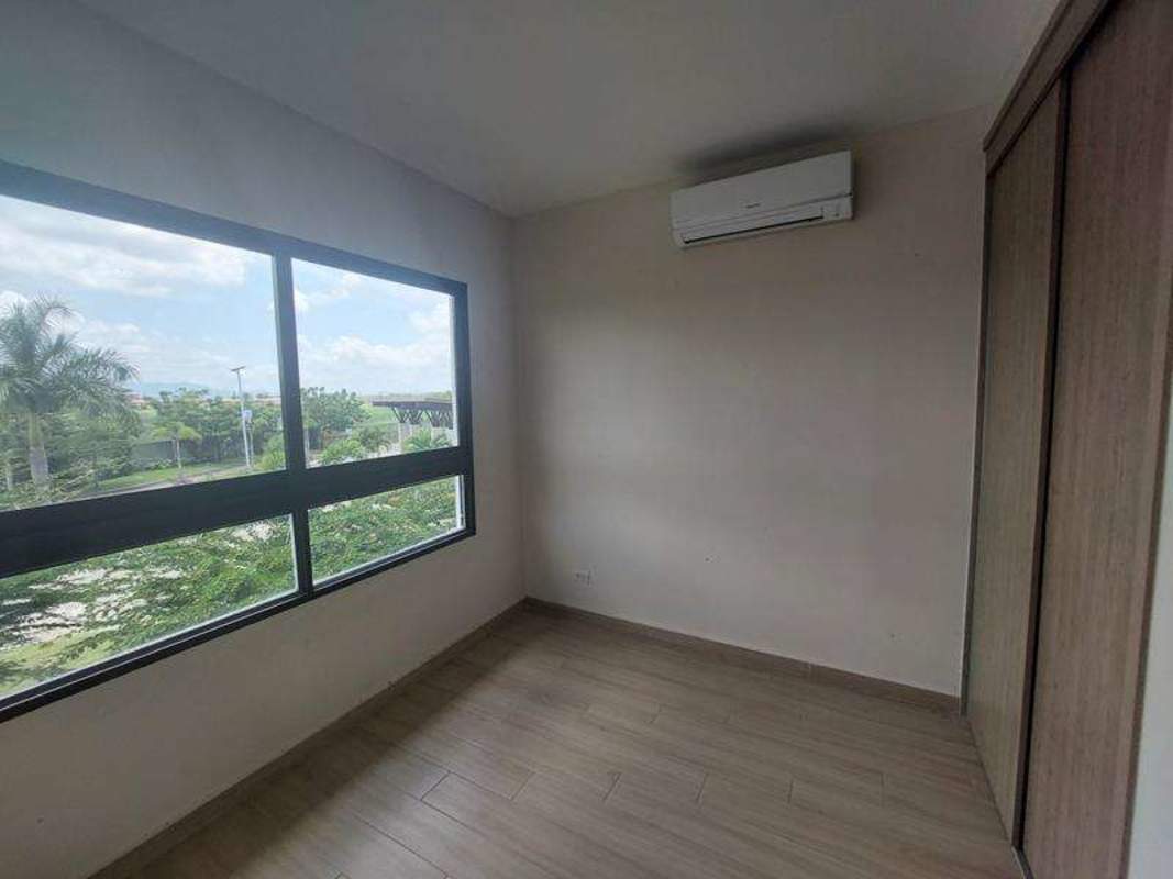 Bedroom with large window, built-in closet, minimalist design in Residencial Costa Sur Village Panama