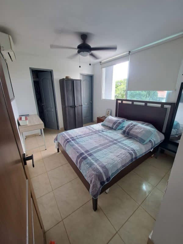 Bright bedroom with AC, ceiling fan, and large window in PH Albrook Residence Clayton Panama