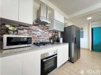 Contemporary beach condo kitchen with granite counters and appliances in Playa Caracol