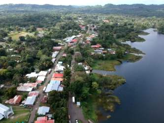 Aerial view of small residential area on waterfront near dense forests Gatun Lake Panama