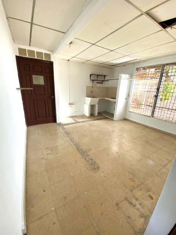 Simple tiled kitchen with brown door and security window near Bethania metro area Panama