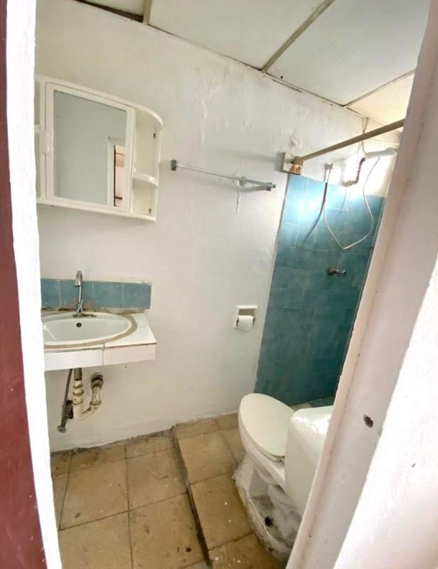 Compact bathroom with blue tiles, mirror cabinet, wall sink near Bethania, Panama City