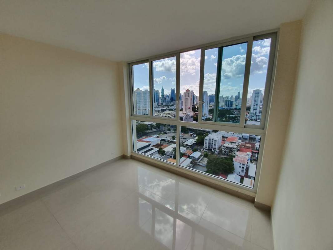 Bedroom with floor-to-ceiling windows showcasing Panama City skyline in PH San Francisco Skyline apartment