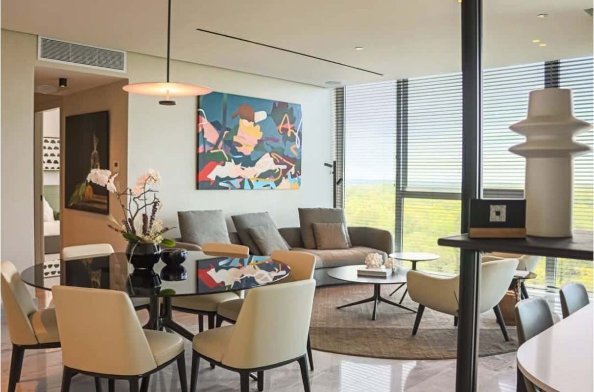 Minimalist dining room with modern pendant light, glass-top table, golf views in Santa María Golf & Country Club Panama