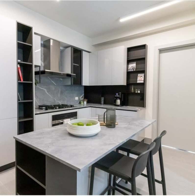 Contemporary kitchen with marble countertops, kitchen island, and built-in stove in Santa María Golf Country Club Panama