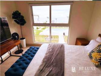 Second bedroom with balcony access pool and garden view at PH Playa Caracol Punta Chame