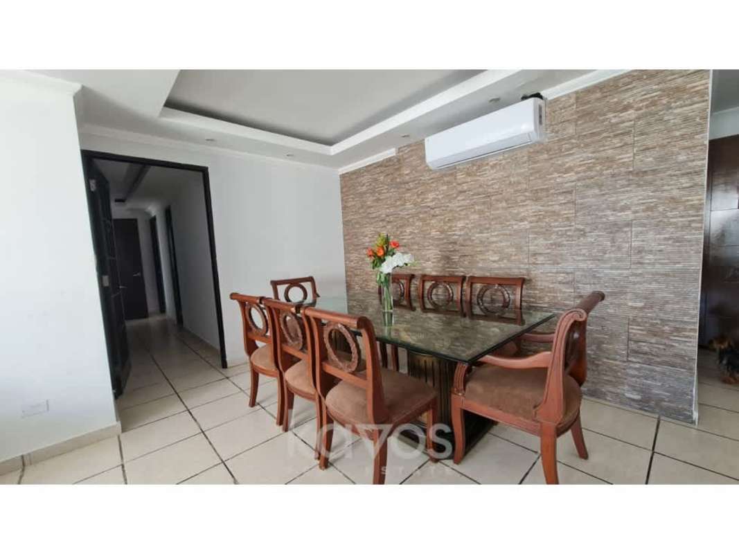 Dining area with glass table, stone accent wall, air conditioning in PH Torres Coco Mar Panama City