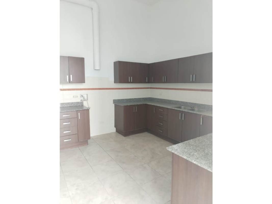 Contemporary penthouse kitchen with granite countertops and wood cabinets PH Kubic El Cangrejo Panama