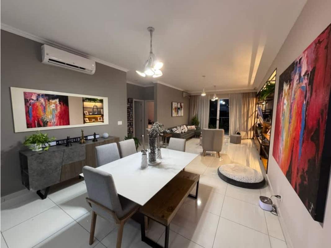 Modern kitchen with granite countertops, breakfast bar and white cabinetry in PH Nautica Panama City