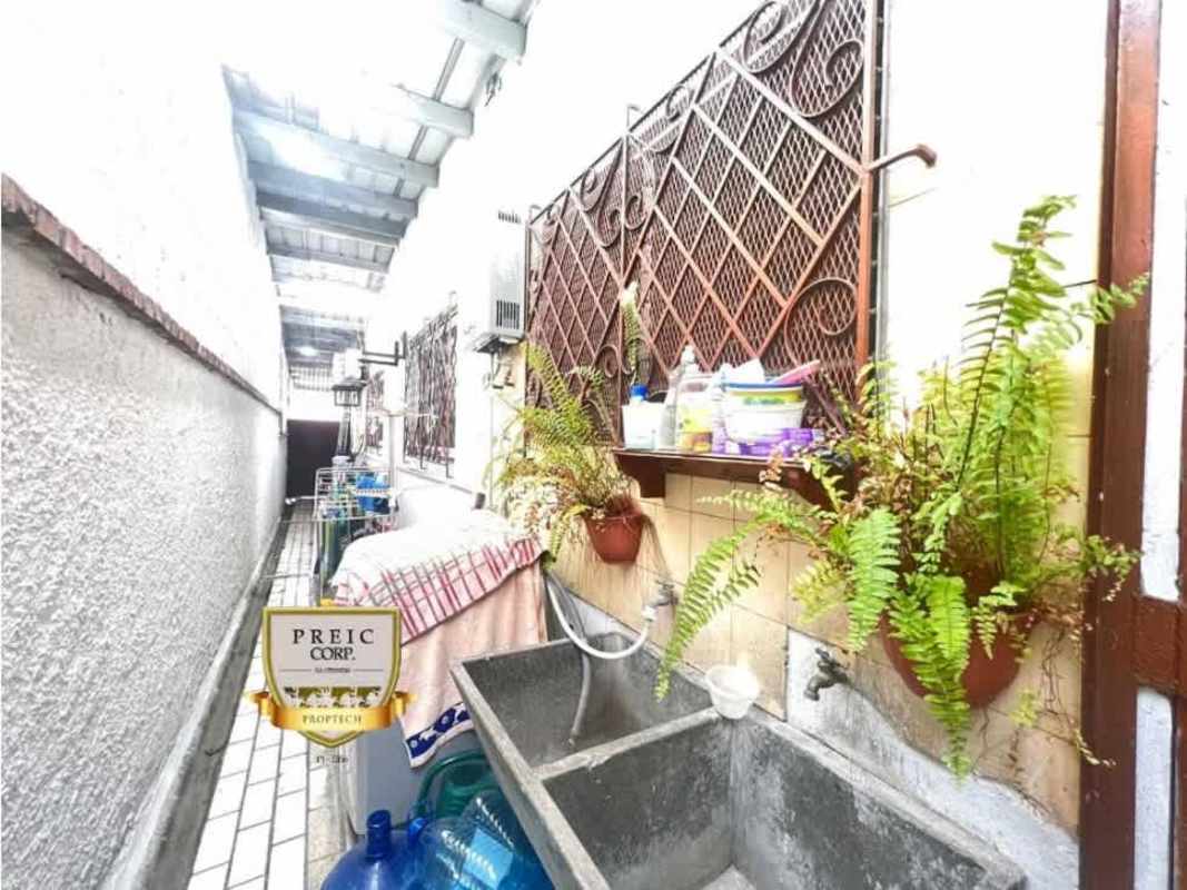 Covered exterior laundry area with sink, hanging plants, and utility storage in Hato Pintado Panama rental house