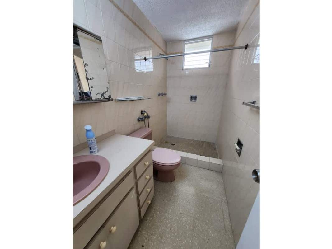 Bathroom with pink basin, shower and tiled walls PH Alameda Panama