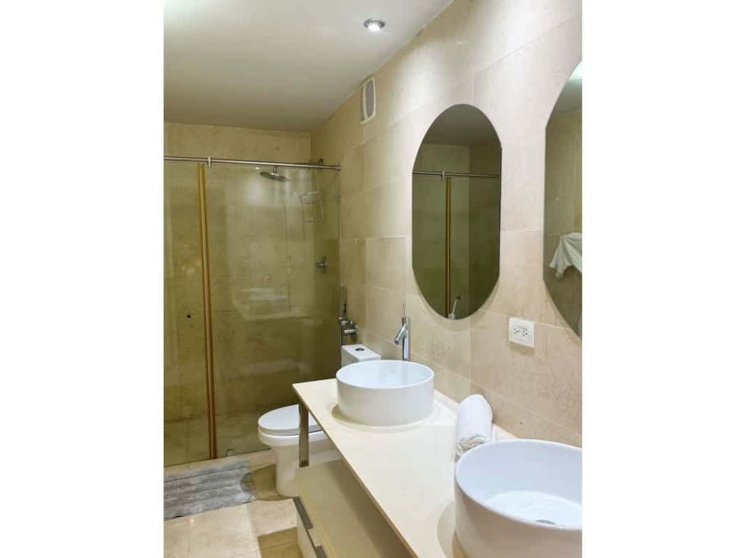 Modern bathroom with double vessel sinks, walk-in shower, luxury finishes at Yoo Panama