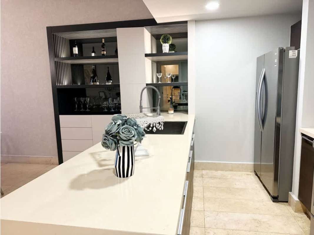Luxury kitchen with island, granite counters, appliances at Yoo Panama Condo