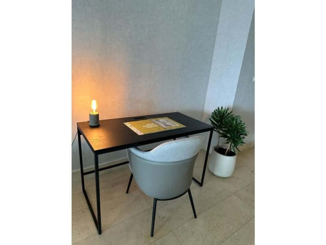 Expansive balcony with glass railing overlooking ocean and skyline in Yoo Panama tower