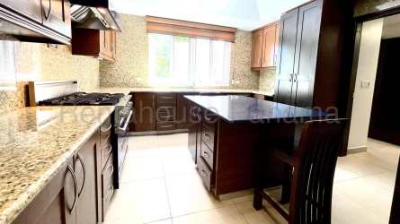 Spacious kitchen with granite countertop island and natural light in Tucan Country Club villa