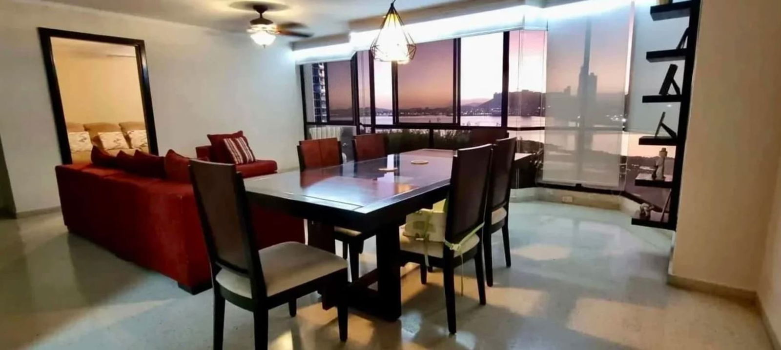 Dining room with skyline and ocean views in luxury Mediterranean apartment