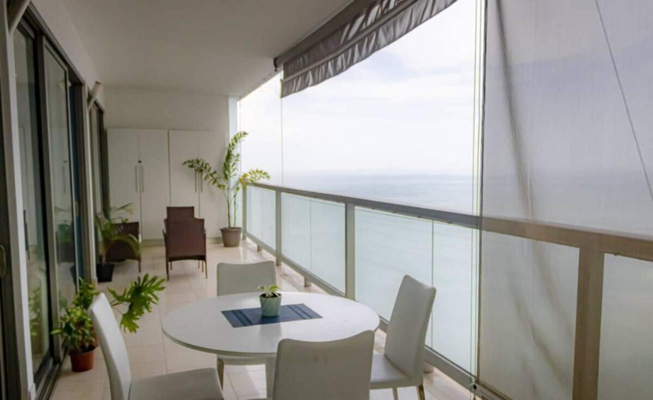 Private balcony with panoramic Pacific Ocean view glass railing JW Marriott apartment