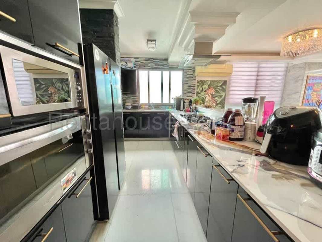 Spacious dining area marble finishes large windows city view PH Ocean Park Panama