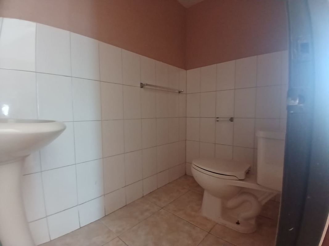 Front of house with gated parking and security fence in Brisas del Golf Panama