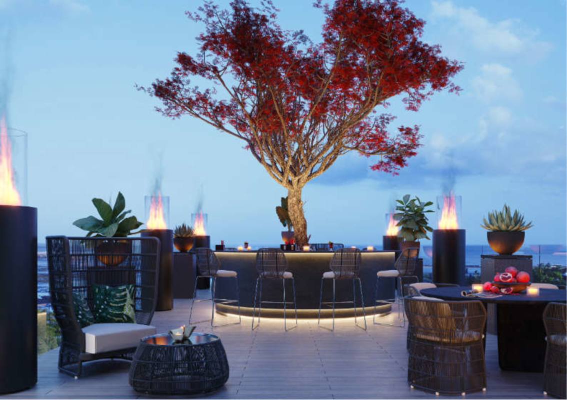 Stylish rooftop terrace with bar under large tree and fire sculptures PH Urbana Panama