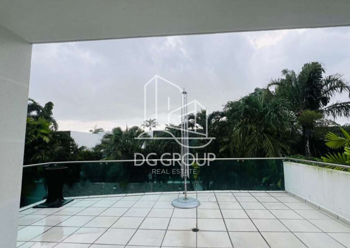 Spacious double-height living room with panoramic windows overlooking private pool PH Costa Esmeralda Costa Sur Panama