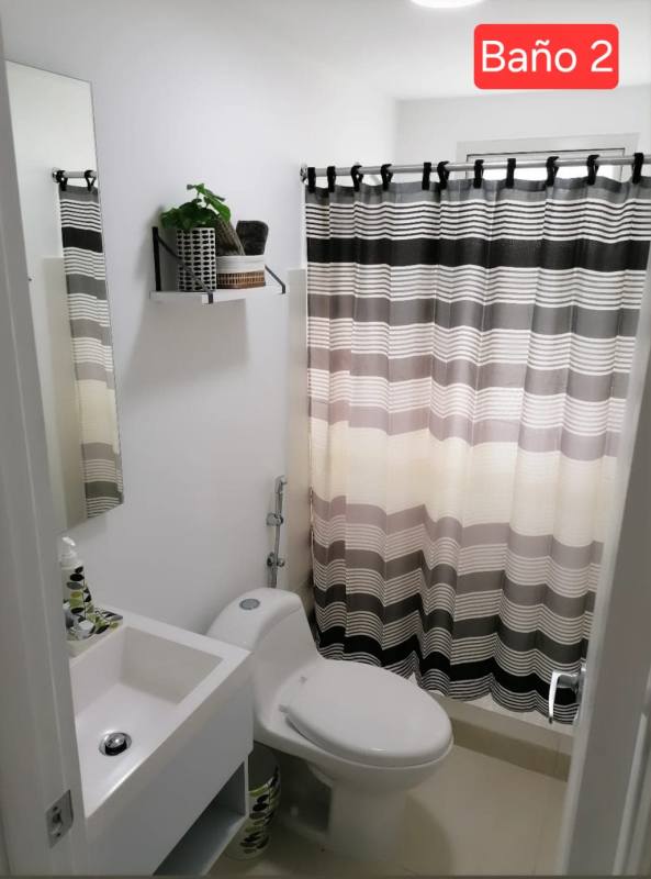 Compact kitchen with granite counters, cabinets, and appliances at PH Panama Viejo Residences Business Center.