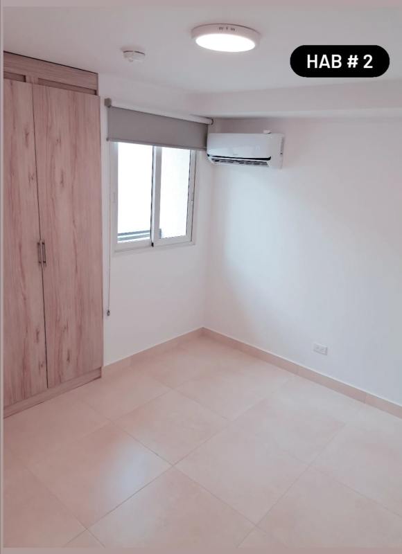 Bedroom with wood wardrobe, AC, modern tiles in PH Panama Viejo Residences Business Center Panama City.